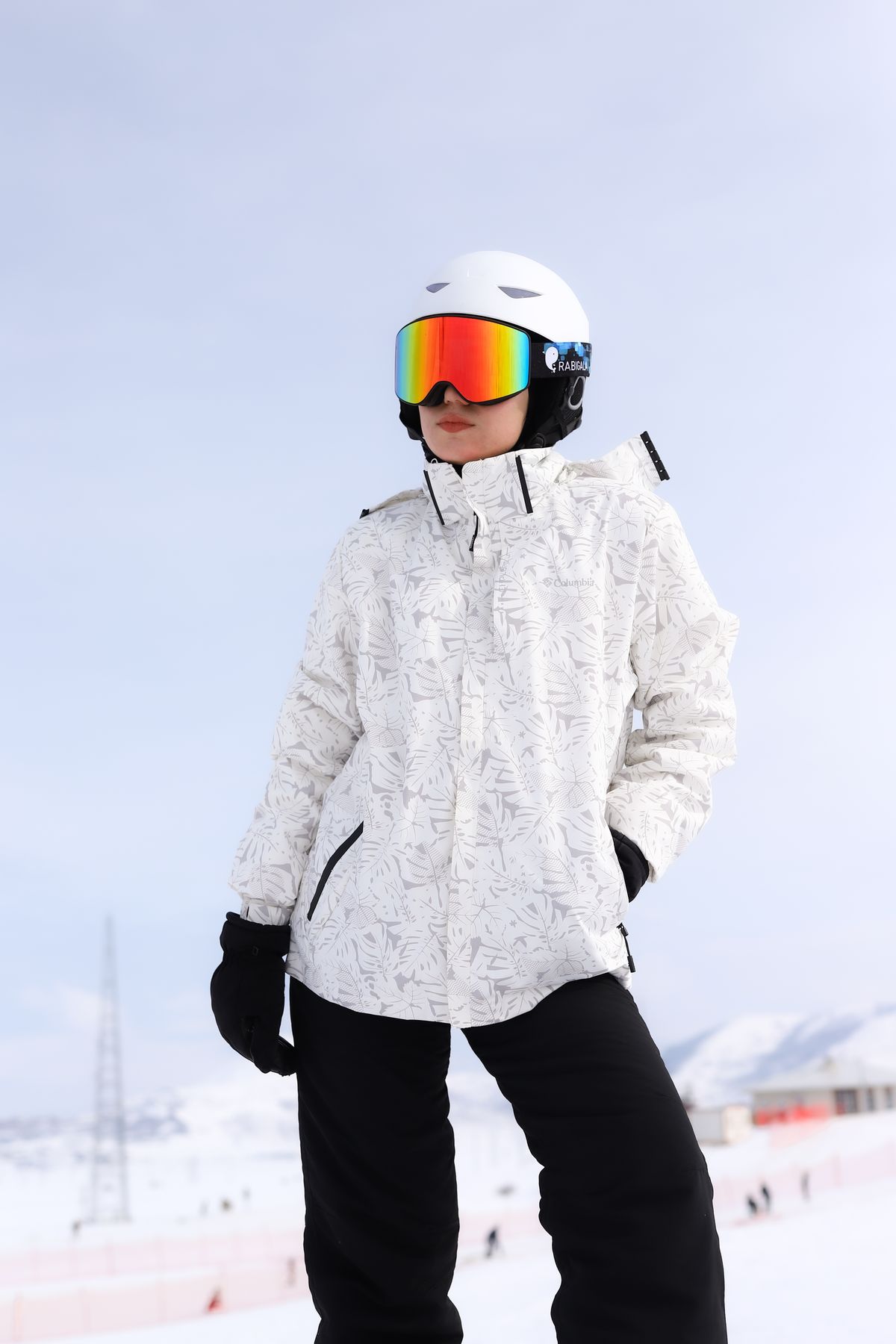 Young skier in helmet and goggles after a run