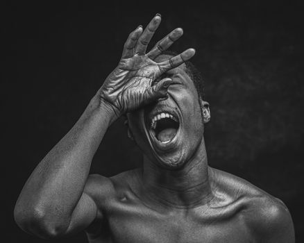 Dramatic black and white portrait capturing intense emotion in a powerful pose.