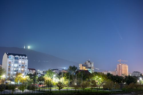 Free Stunning view of Skopje's cityscape with comet and night sky Stock Photo