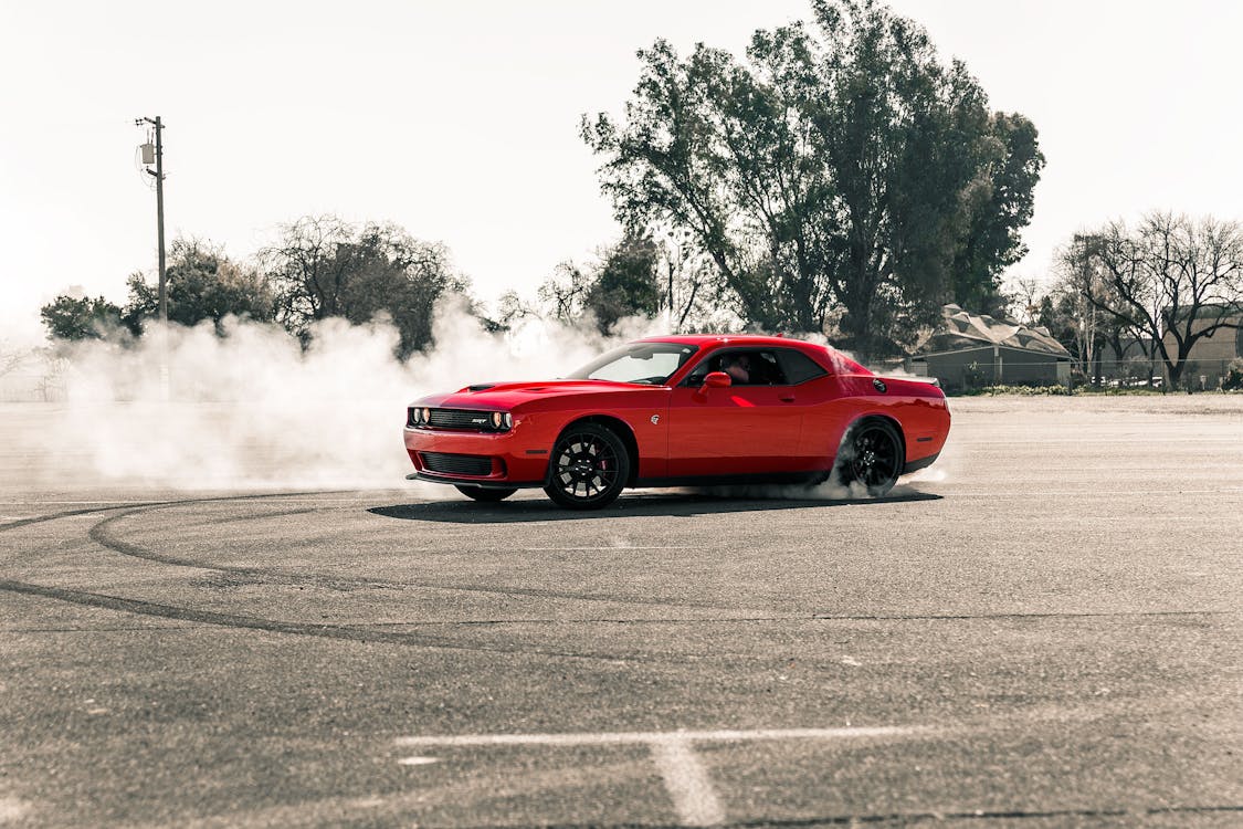 Free Red Coupe Drifting on Asphalt Road Stock Photo