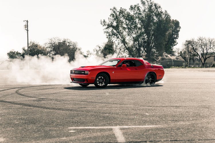 Red Coupe Drifting On Asphalt Road