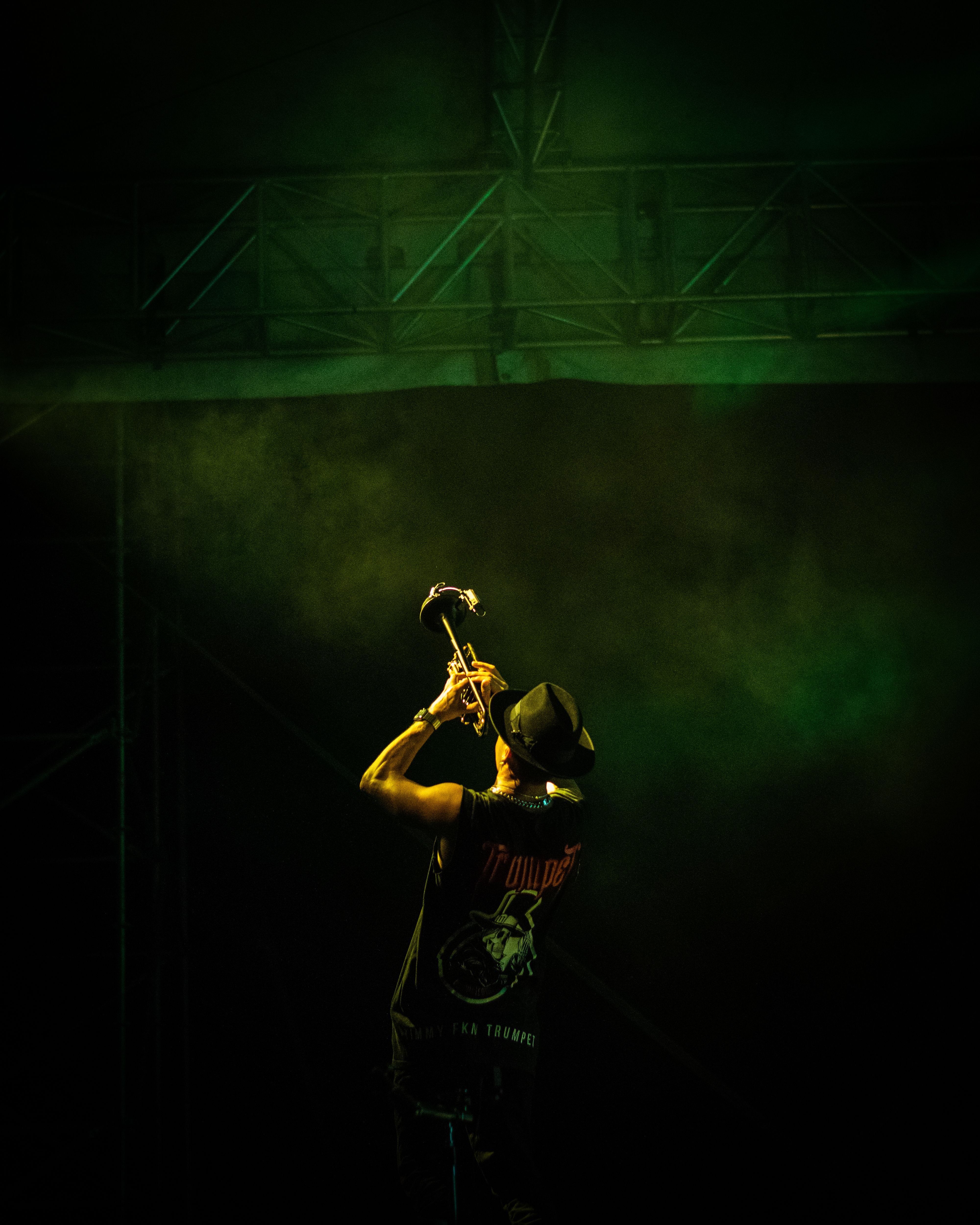 Dynamic trombone player performing on stage with dramatic lighting.
