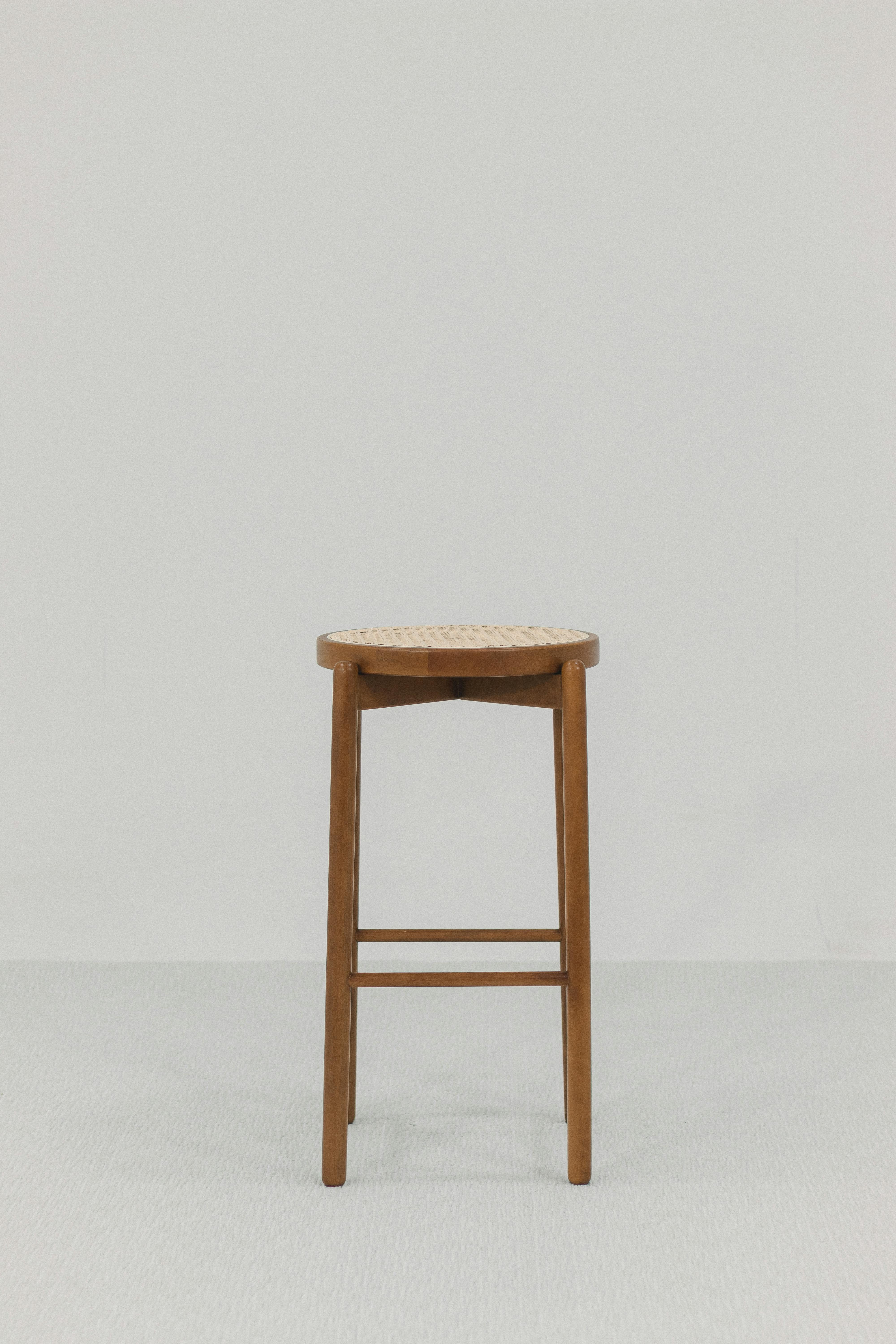 Free Simple brown wooden stool against a plain white backdrop, perfect for design use. Stock Photo
