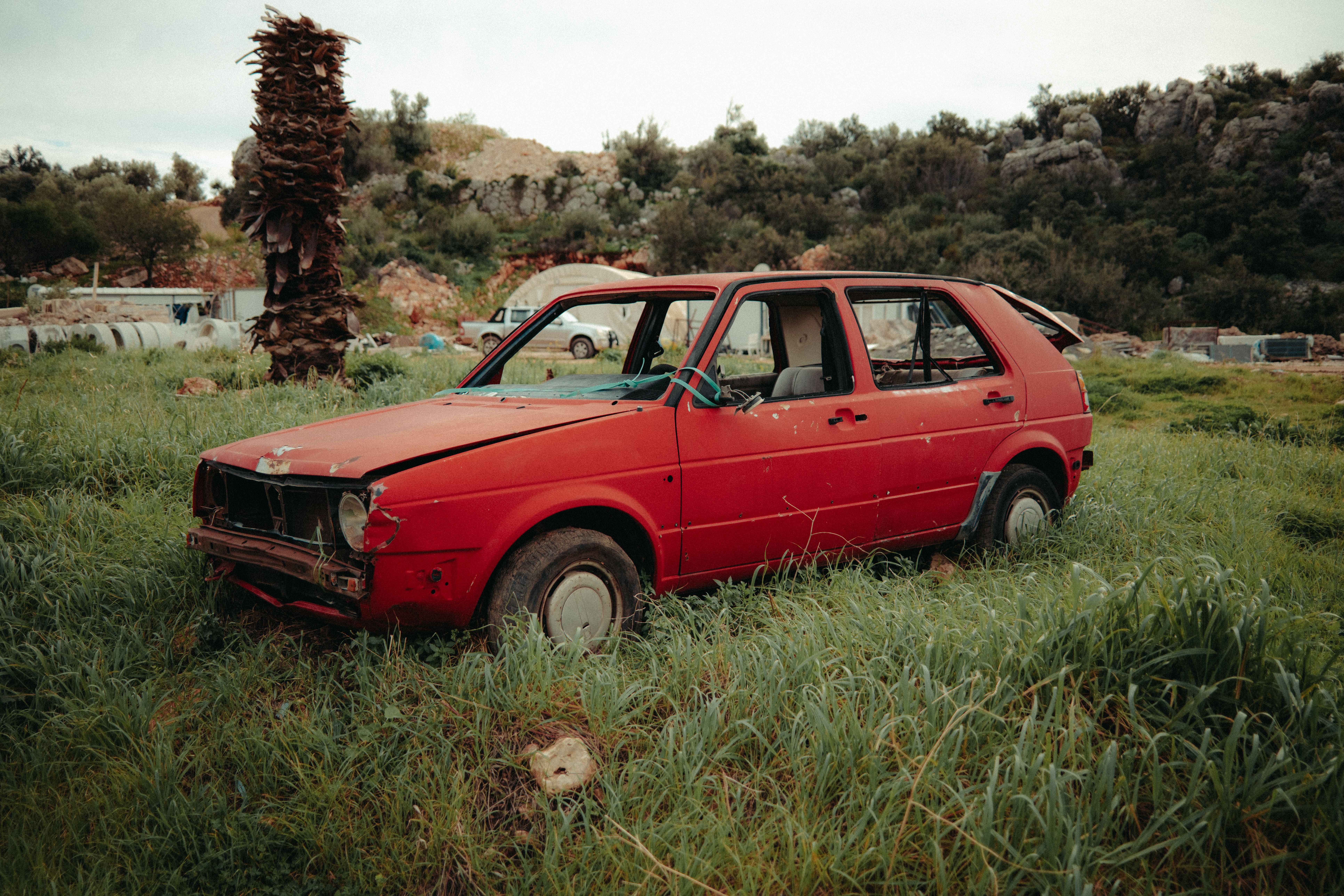 Abandoned Red Car in Overgrown Field · Free Stock Photo