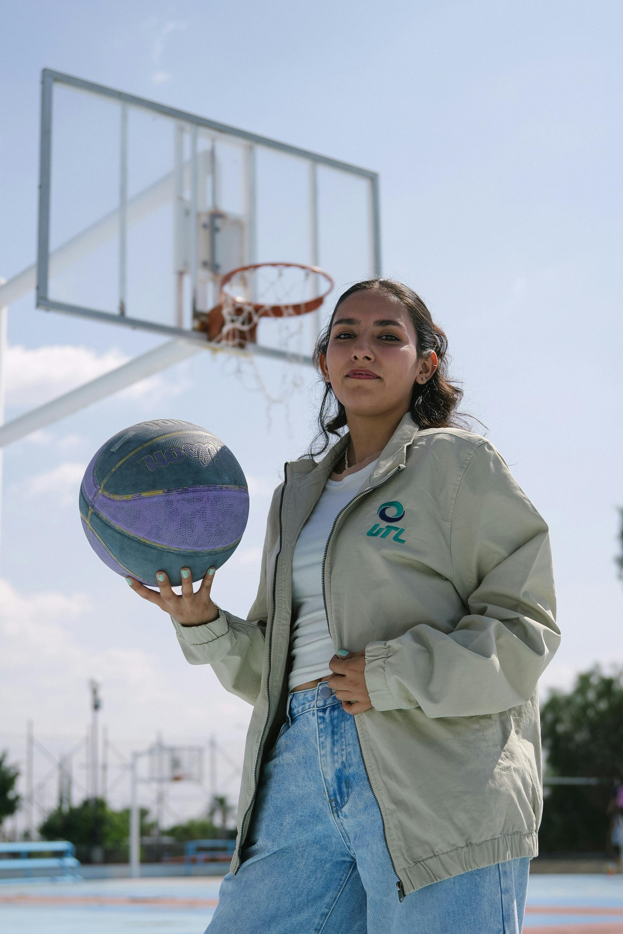 ingyenes Magabiztos fiatal nő kosárlabdával a kezében egy szabadtéri pályán Leónban, Mexikóban. Stockfotó