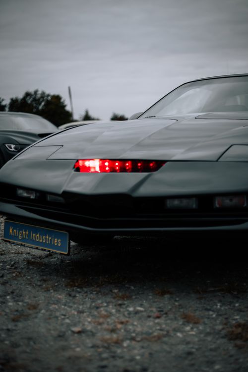 Free Dynamic close-up of a black sports car featuring a futuristic LED light design. Stock Photo