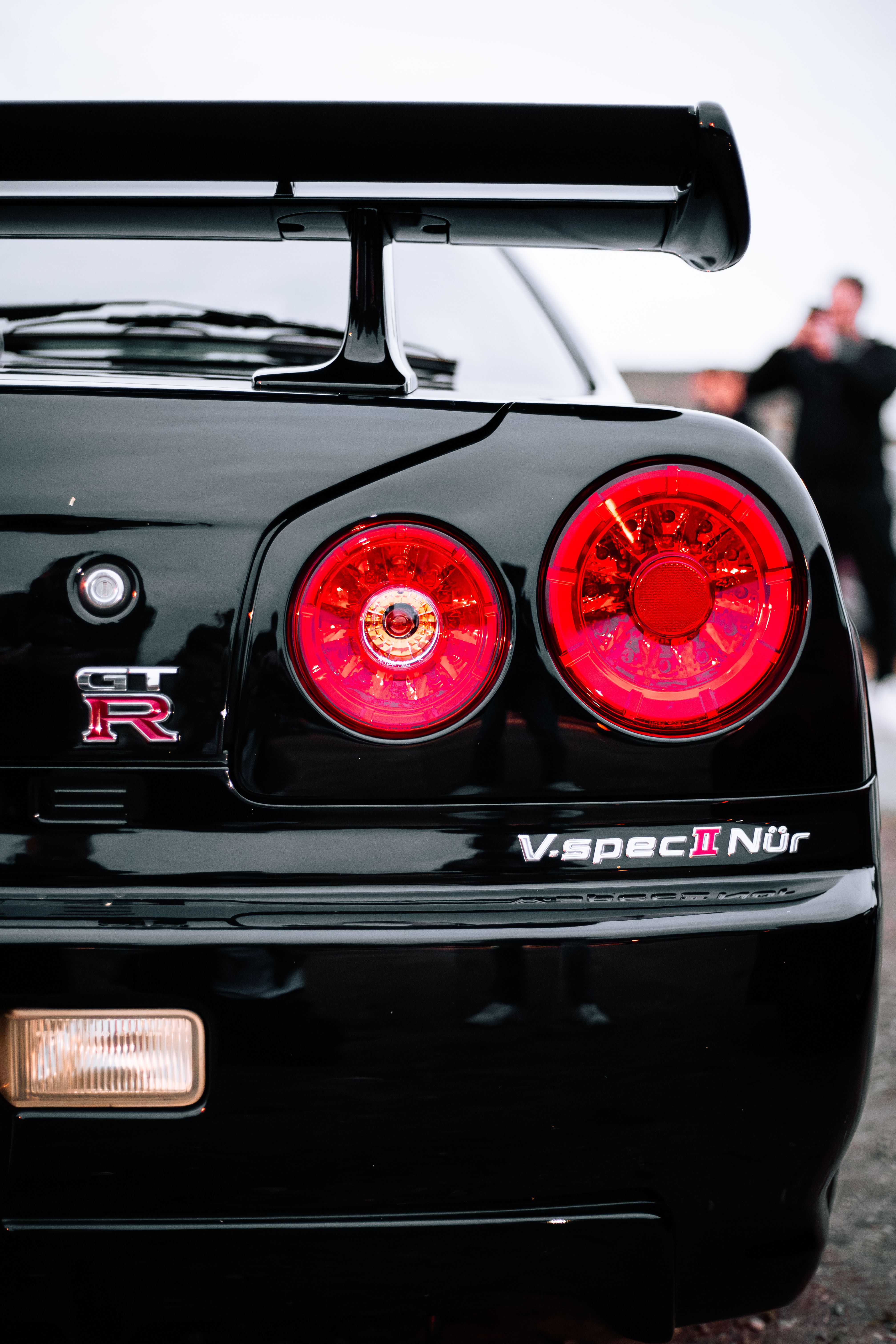 Close-Up of Black Sports Car Tail Lights · Free Stock Photo