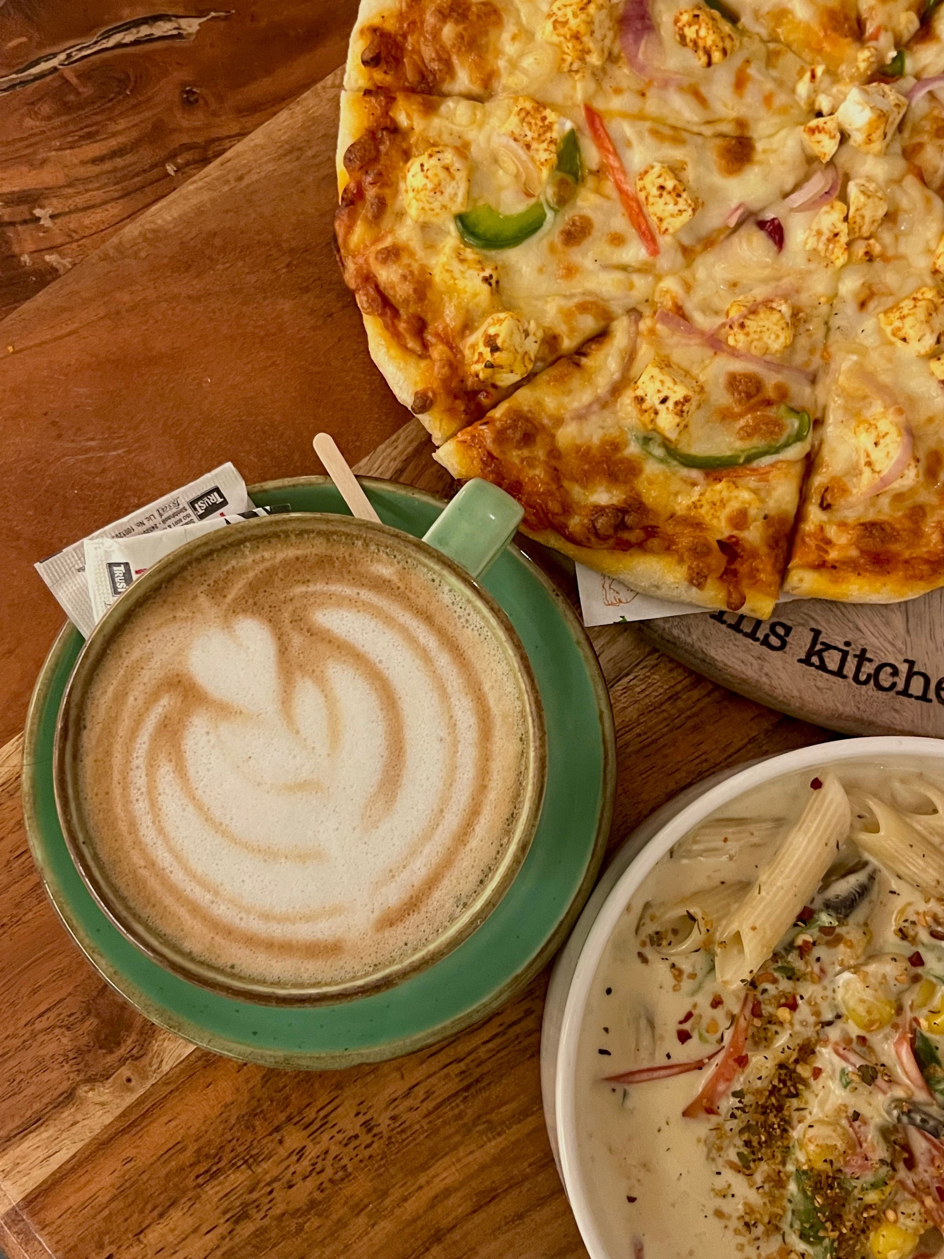 Cozy Cafe Meal with Pizza, Pasta, and Latte · Free Stock Photo
