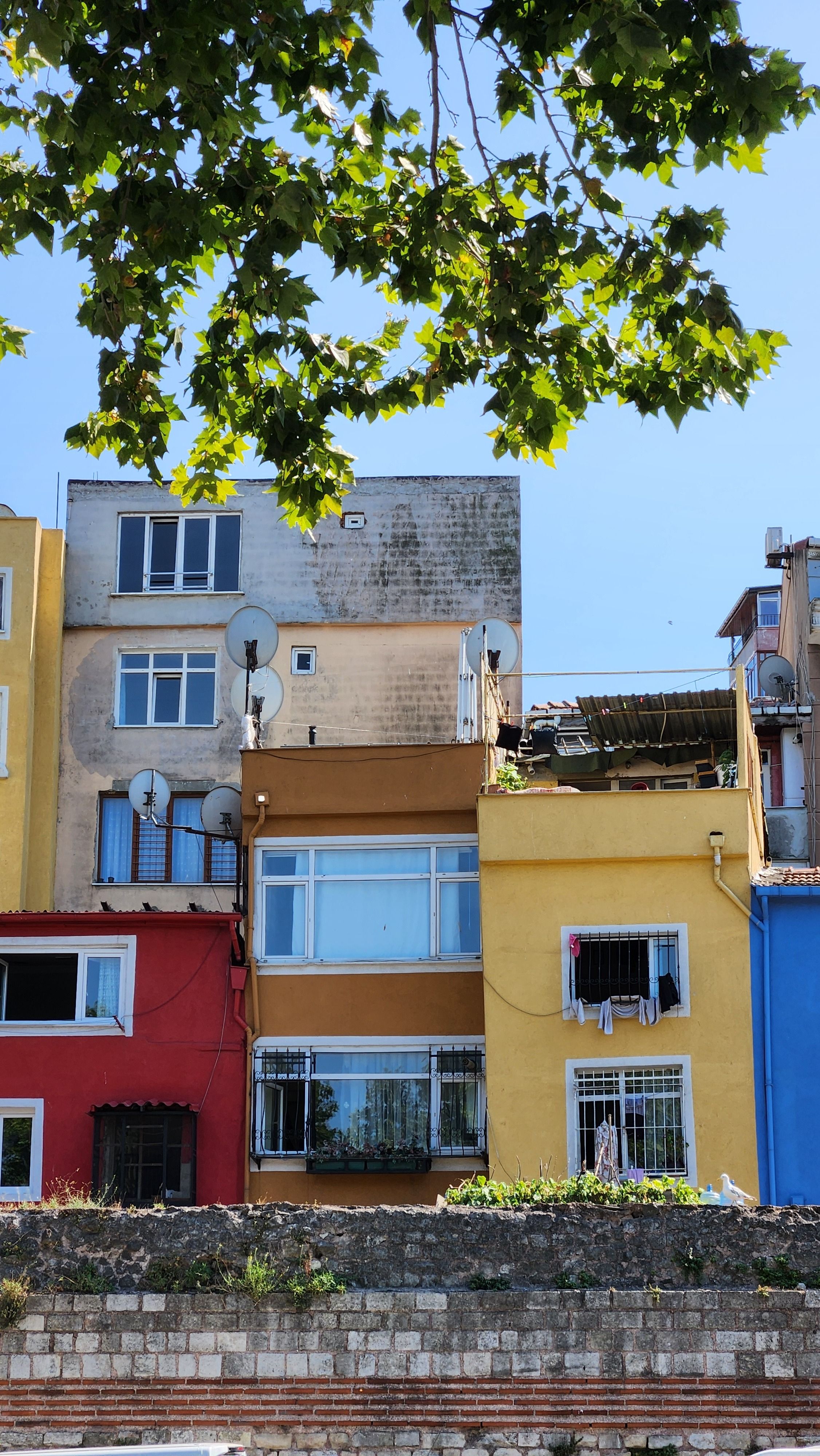 Vibrant multicolored houses in Istanbul's urban landscape, showcasing diversity and architectural charm.