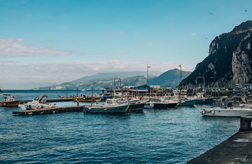 Free Picturesque view of boats docked at a harbor on the scenic Amalfi Coast, Italy during the day. Stock Photo
