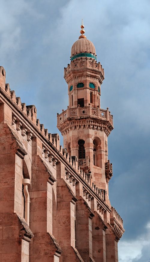 Free A beautiful minaret in Algiers, Algeria, stands tall against a dramatic cloudy sky, showcasing intricate architecture. Stock Photo