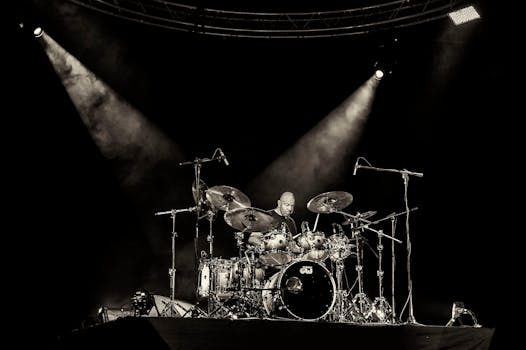 Dynamic concert scene with a drummer rocking on stage under spotlights in San Salvador.