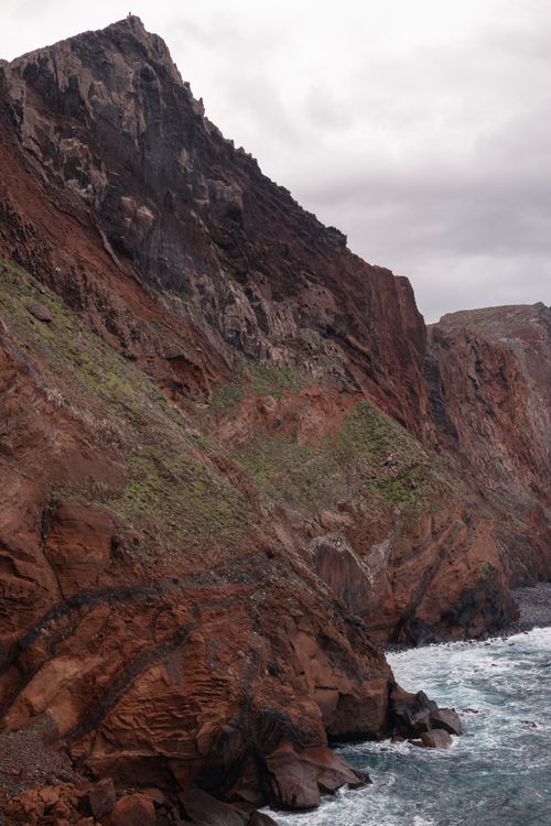 Free Dramatic cliffs of Madeira Island with waves crashing against the rocky shore. Stock Photo