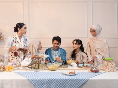 Indonesian family enjoying a traditional meal during Ramadan in Jakarta.