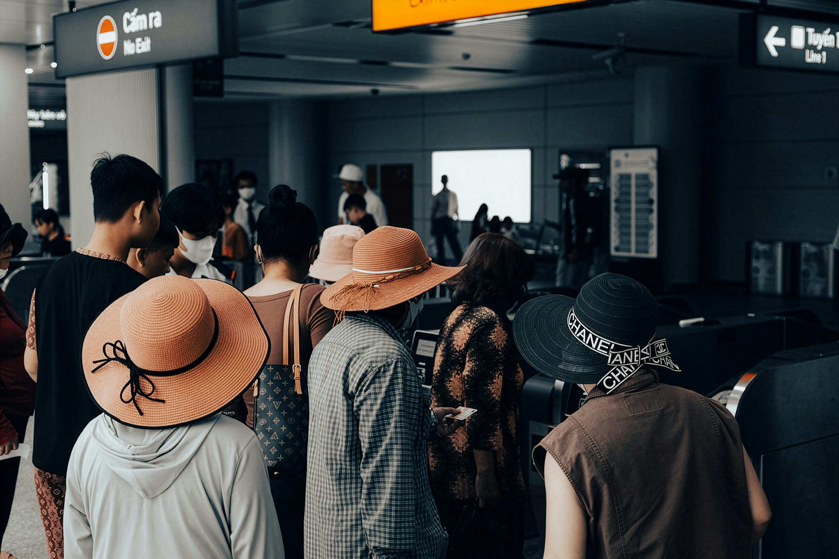 Free People gathering at a busy station entrance in Ho Chi Minh City, Vietnam, showing diverse styles and fashion. Stock Photo