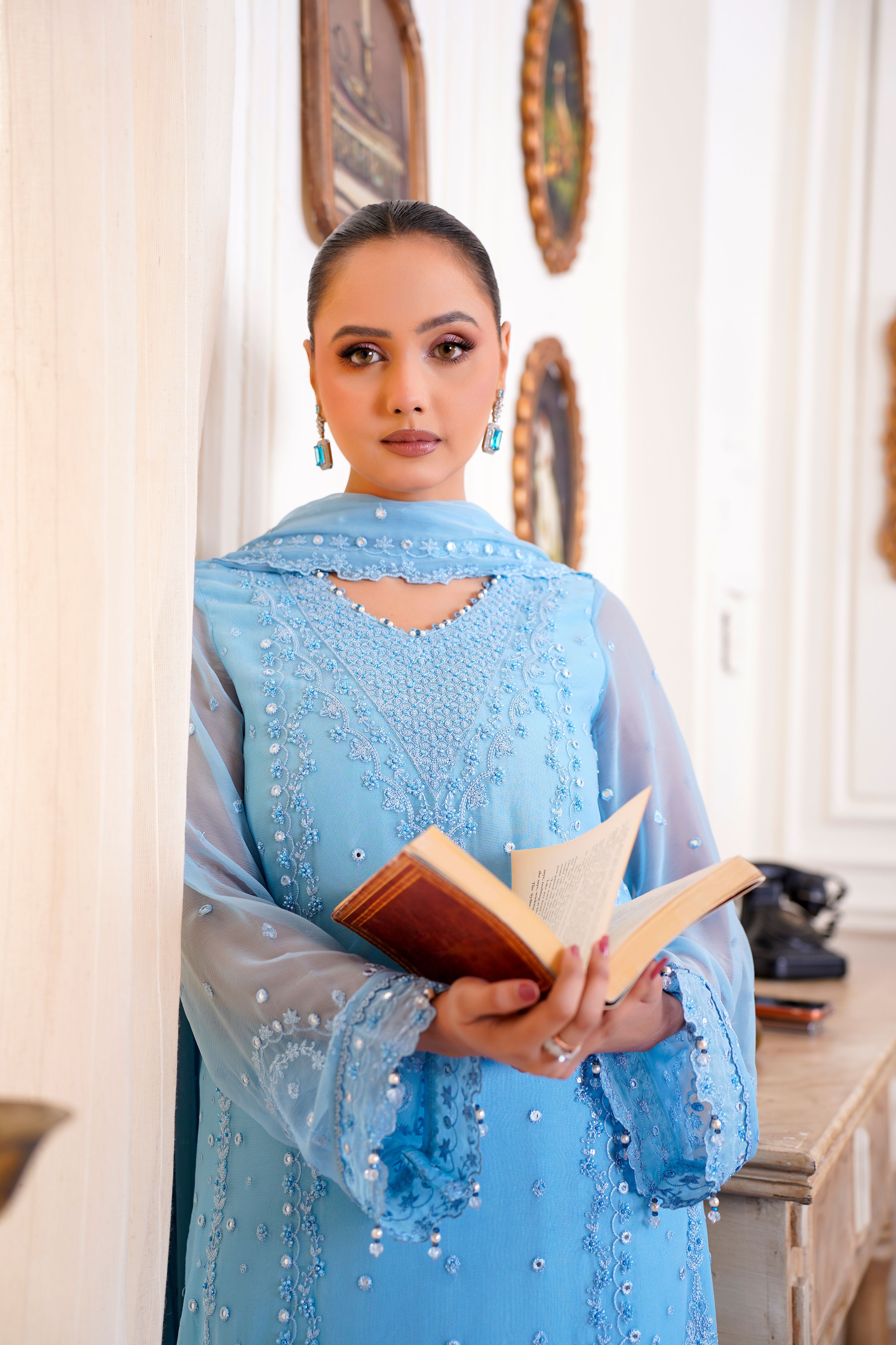 Elegant Woman in Blue Traditional Dress Holding Book · Free Stock Photo