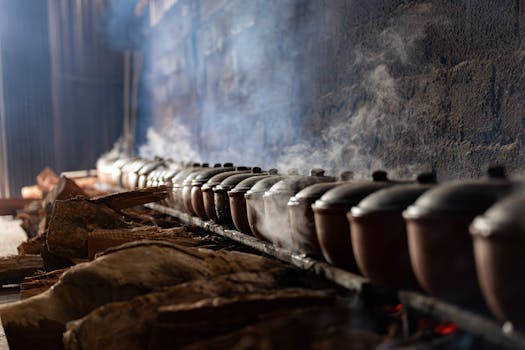 Rows of steaming clay pots in a traditional Vietnamese kitchen in Nam Định, Vietnam, create an authentic culinary atmosphere.