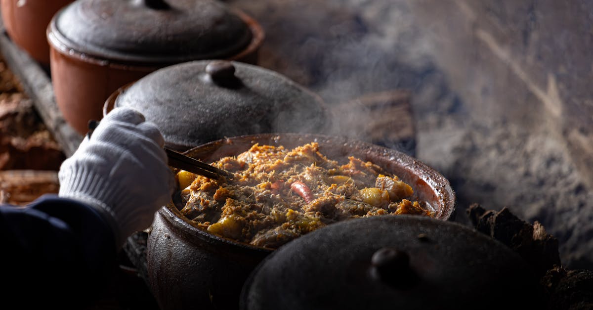 Steaming hot Vietnamese dish cooking in clay pots over rustic stove, adding authentic flavor.