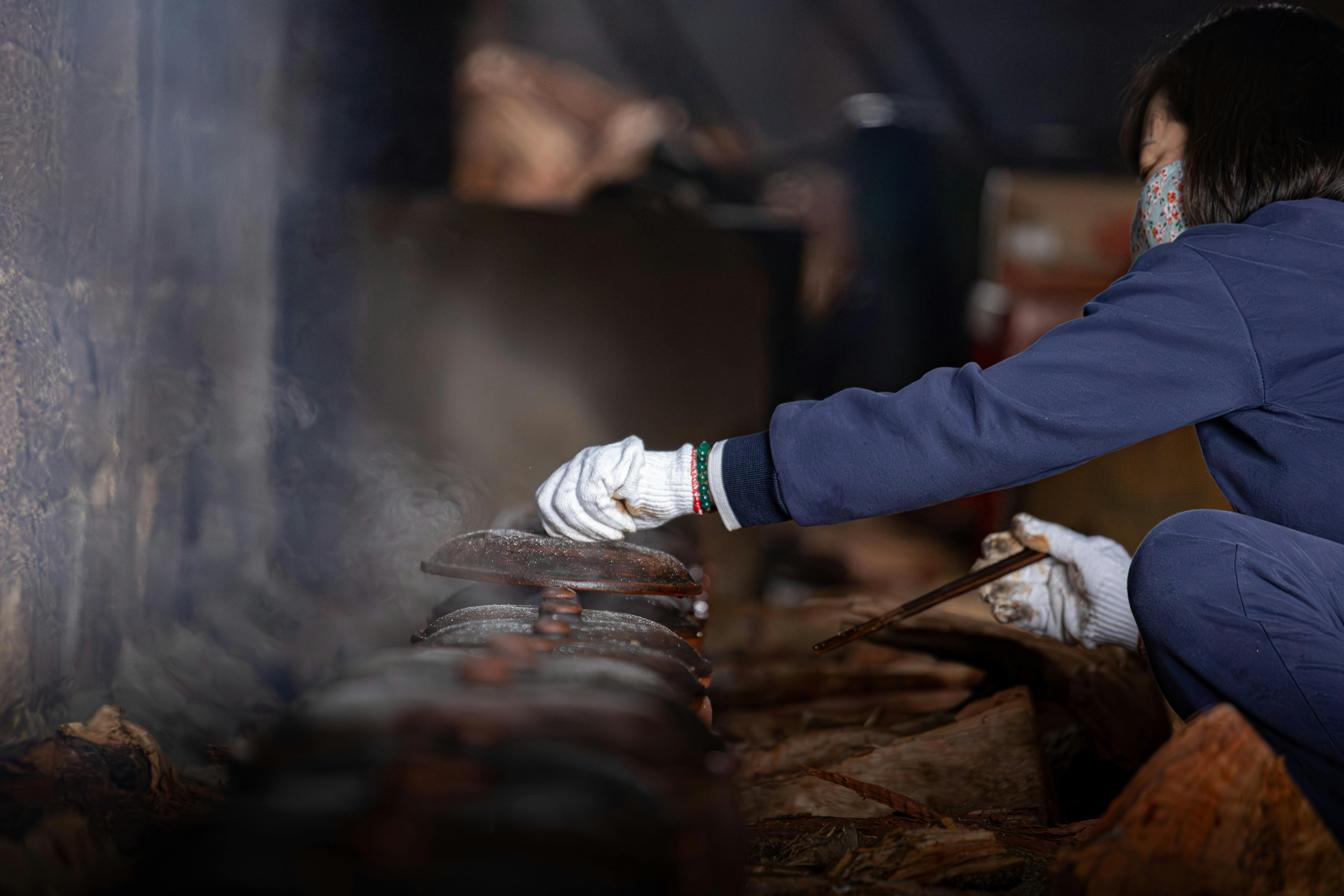 Close-up of a person making incense traditionally in Nam Định, Vietnam.
