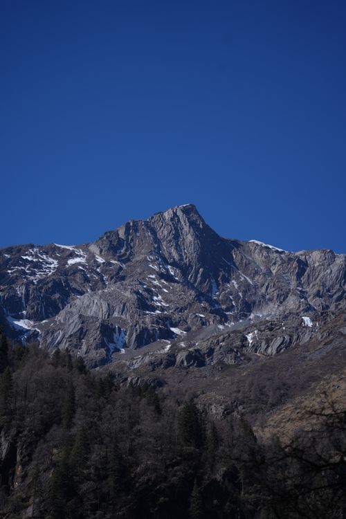 Free Stunning view of a rugged mountain peak under a bright blue sky, showcasing natural beauty. Stock Photo