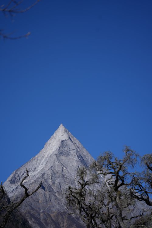 Free Stunning view of a snow-capped mountain peak against a clear blue sky, embracing the serenity of nature. Stock Photo