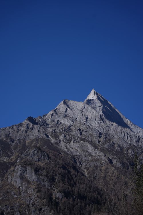 Free Stunning view of a sharp mountain peak under a bright blue sky, capturing natural beauty and serenity. Stock Photo