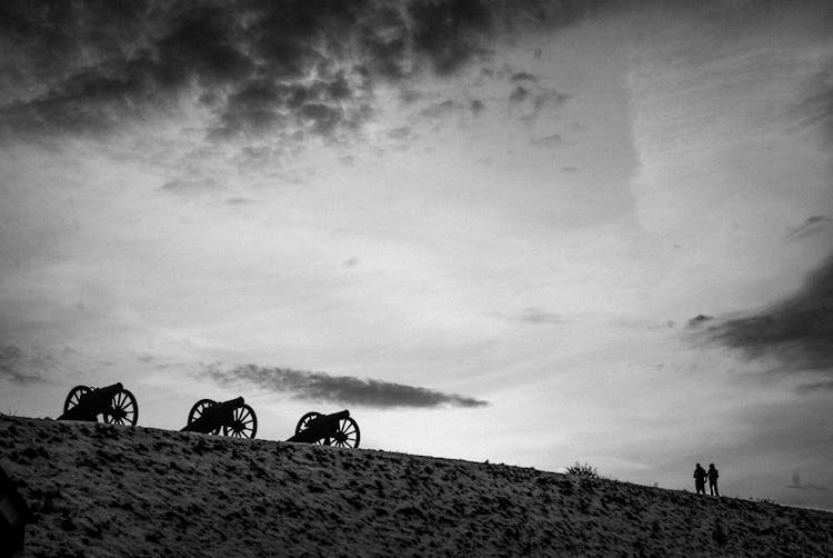 Grayscale Photo Of People And Canyons