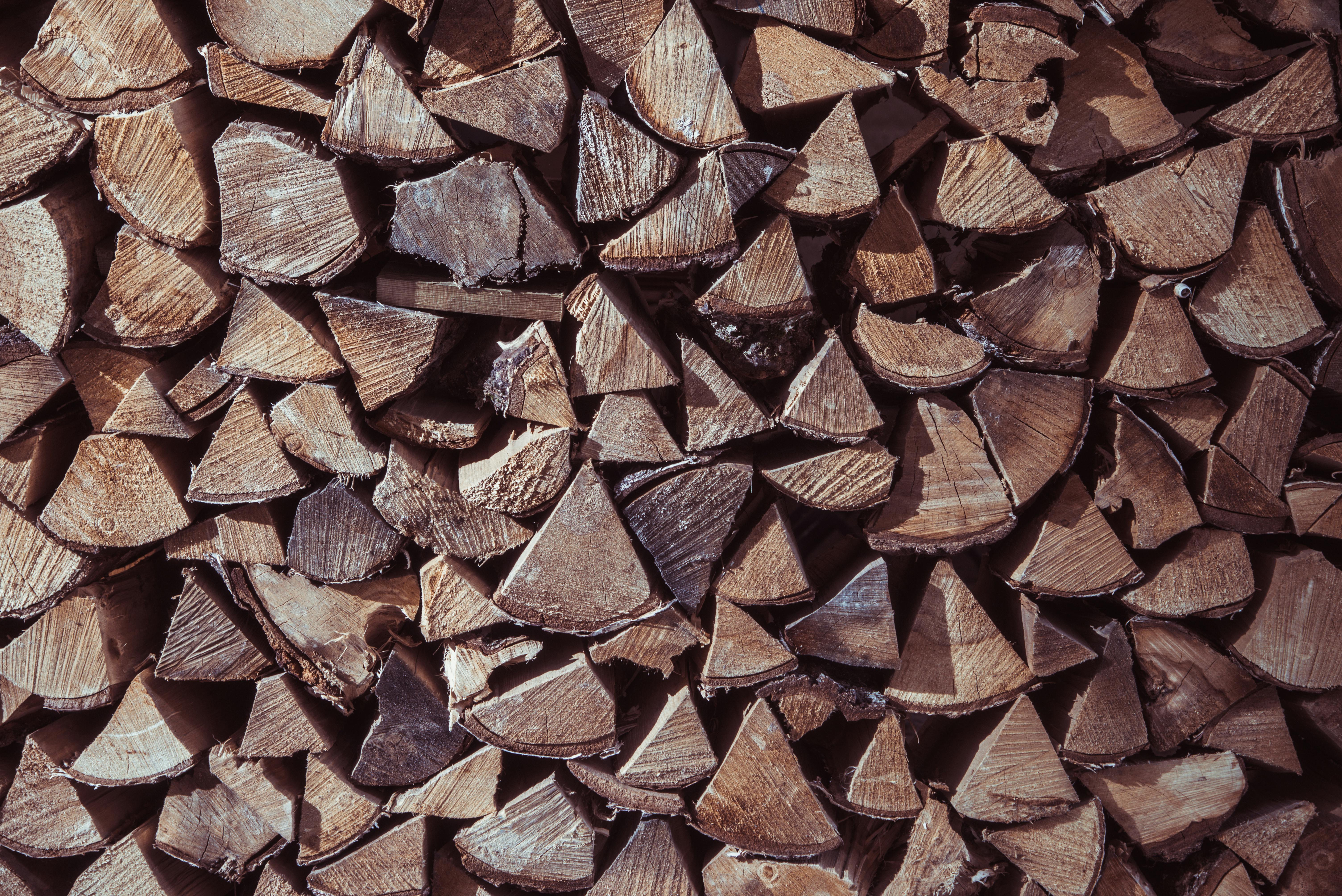 Free Close-up view of stacked firewood displaying natural textures and earthy tones. Stock Photo