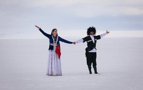 Caucasian dancers in traditional attire on a snowy landscape in Arpaçay, Kars, Türkiye.