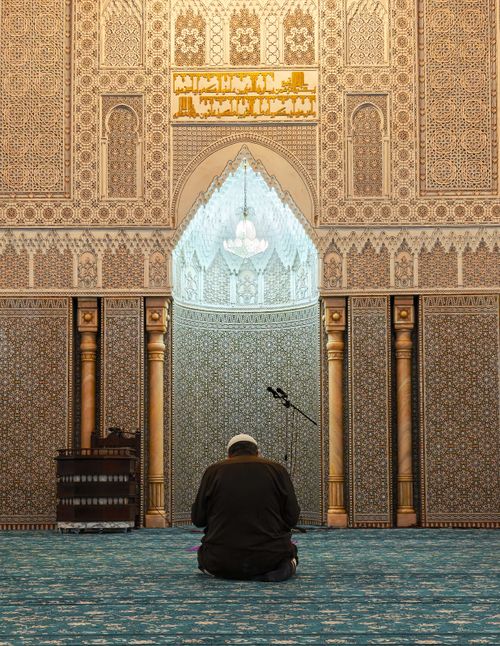Free A man praying in the grand interior of a Constantine mosque, Algeria. Stock Photo