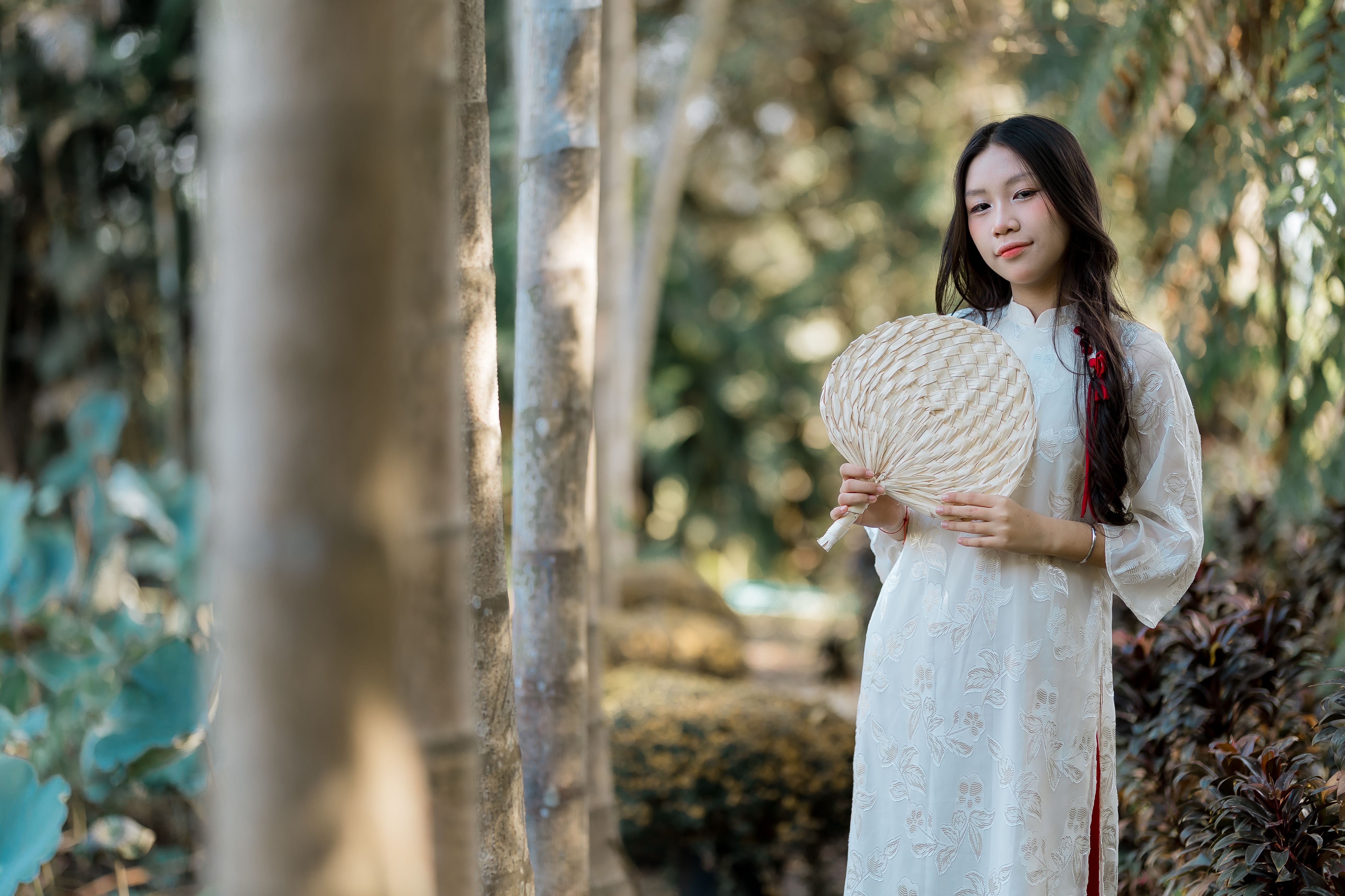 Young Woman in Traditional Dress with Fan Outdoors · Free Stock Photo