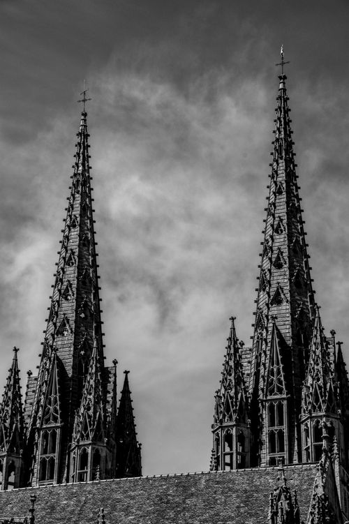 Free Black and white photo of Gothic cathedral spires in Brittany, France with dramatic sky. Stock Photo
