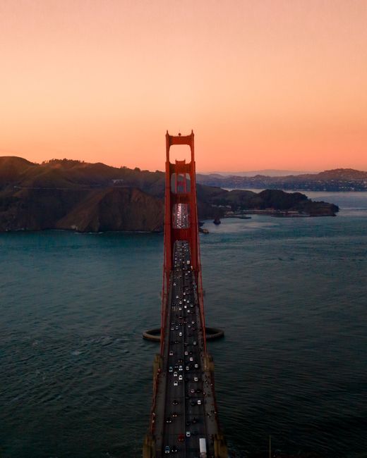 A stunning aerial view of the Golden Gate Bridge at sunset, showcasing San Francisco's iconic landmark.