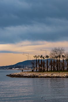 Tranquil seaside promenade under dramatic evening skies, perfect for peaceful strolls.