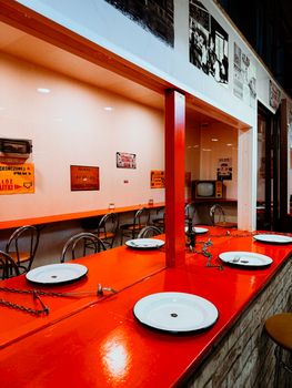 Empty diner with red counter and retro decor in Breslau, Poland.