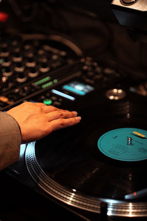 Free Close-up of a DJ's hand spinning a vinyl record at a club in Tokyo, capturing the essence of nightlife and music culture. Stock Photo