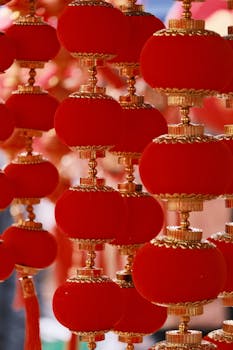 Close-up of traditional Chinese red lanterns with gold accents, symbolizing good luck.