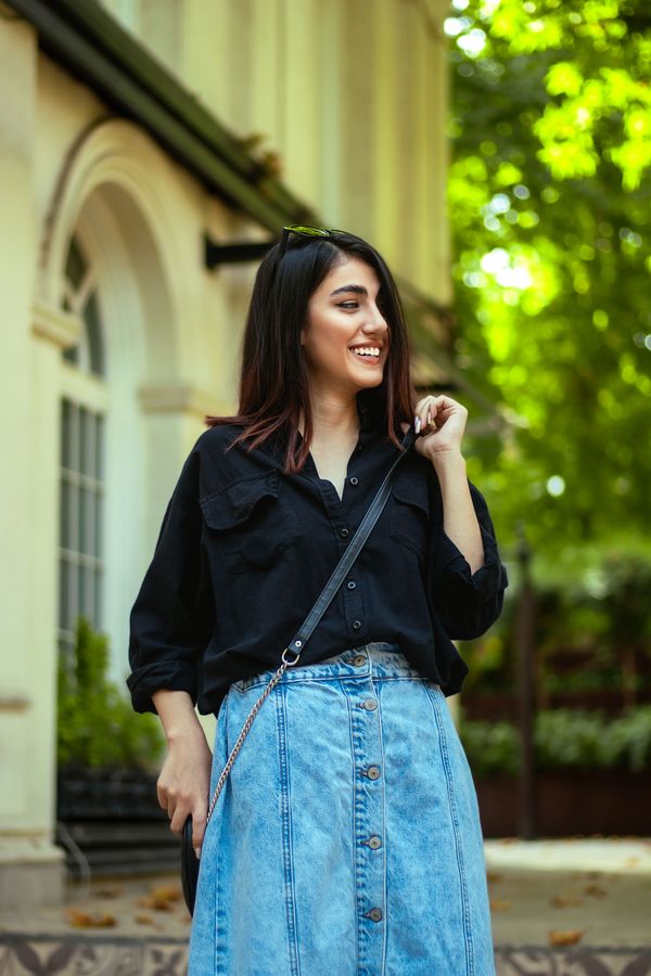 Model in a denim midi skirt and black top, photo by Mehti Jabari on Pexels