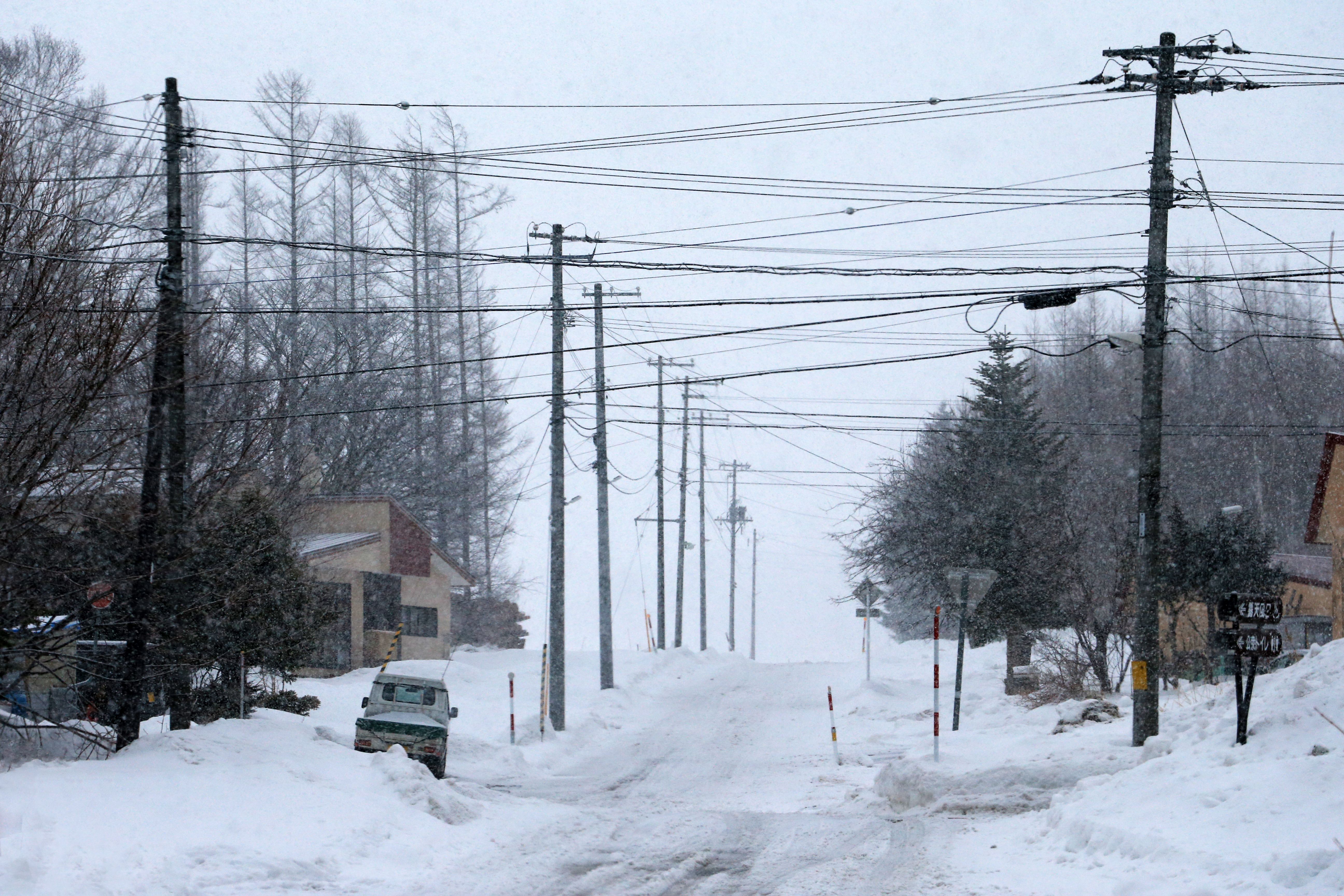Ice-laden power lines sagging near a residential home