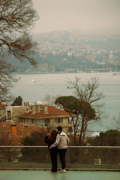 Free A couple enjoys a romantic moment with a stunning view of the Bosphorus in Istanbul, Türkiye. Stock Photo