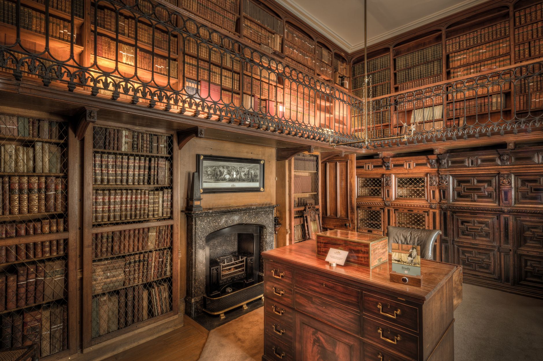A sophisticated minimalist private library featuring bespoke furniture and a curated collection of academic volumes in soft lighting.