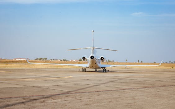 A private jet parked on an airport runway in Jos, Nigeria, under clear skies.