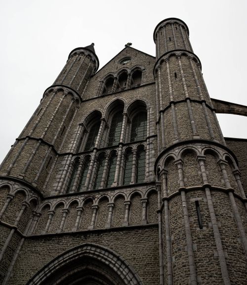 Free Dramatic view of a gothic church facade in Bruges, showcasing intricate architecture. Stock Photo