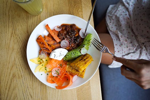 Colorful vegetarian meal with avocado, beans, and corn served on a wooden table. Ideal for healthy lifestyle visuals.
