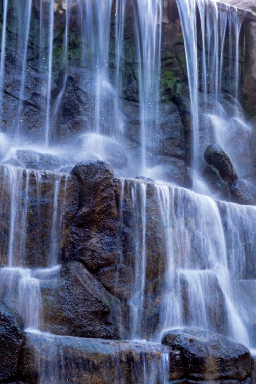 Free A tranquil waterfall cascading over rugged rocks, creating a serene natural scene. Stock Photo