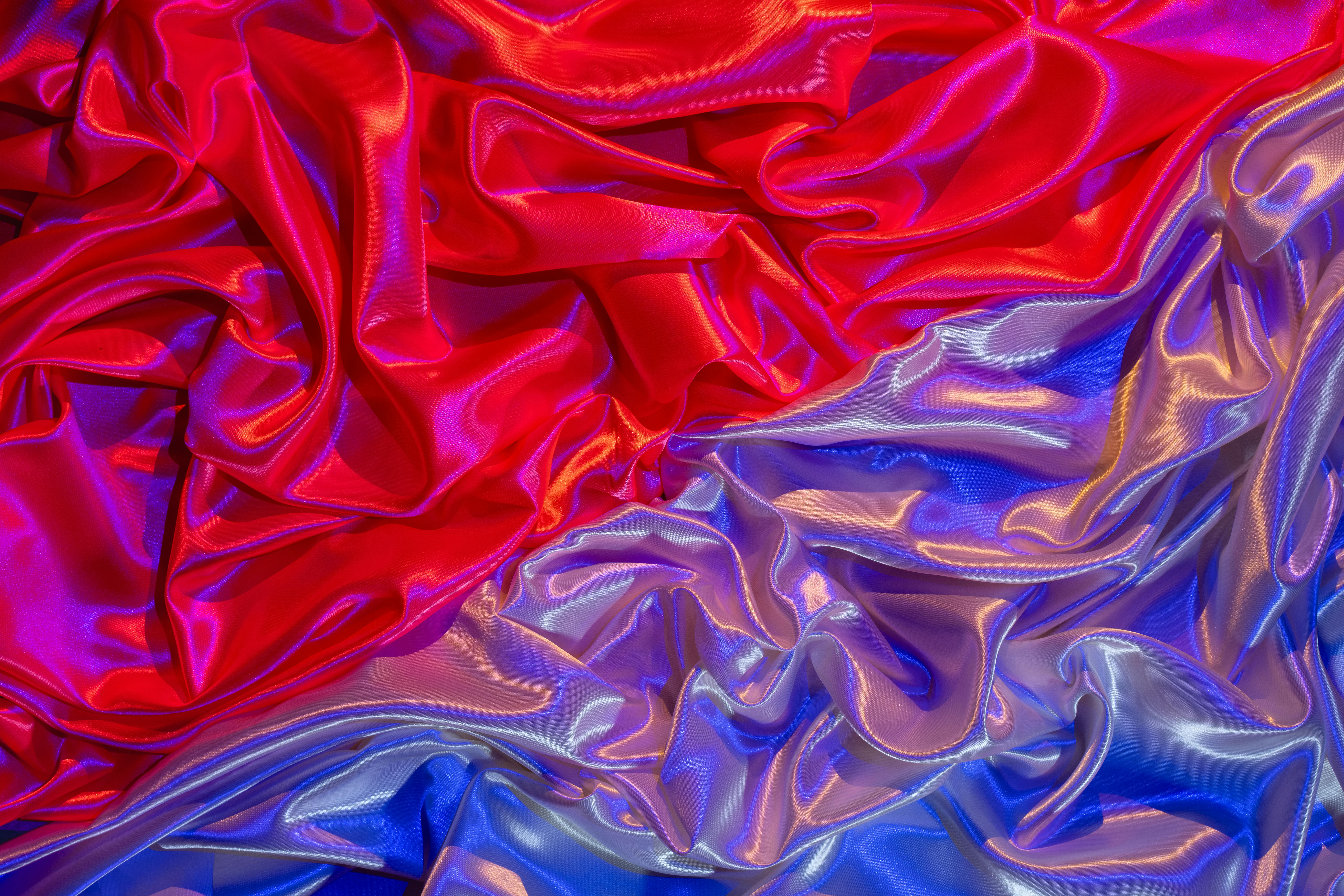 Free Colorful silky fabric in vibrant red and blue with glossy textures and ripples. Stock Photo