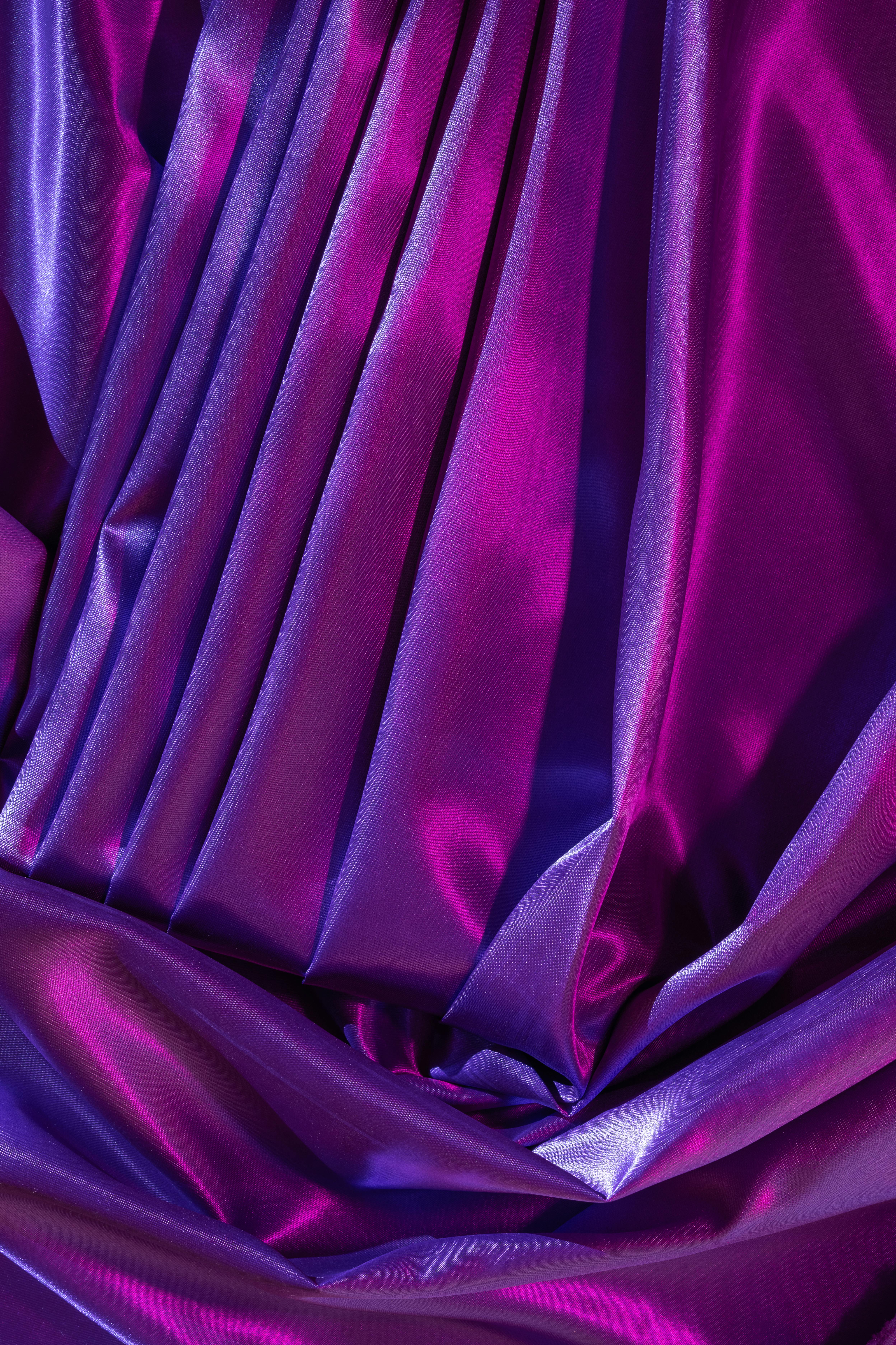 Free Close-up of vibrant, colorful silk fabric with luxurious folds and glossy texture. Stock Photo