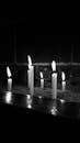Black and White Candles in Dark Setting