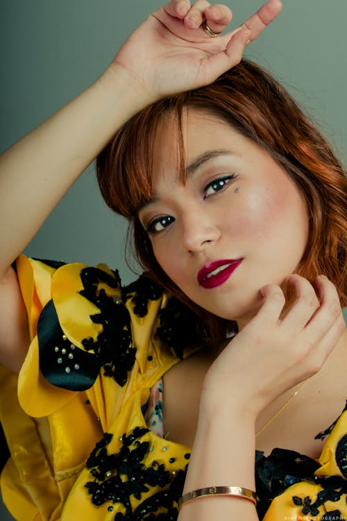 Woman Wearing Yellow and Black Floral Sleeveless Top