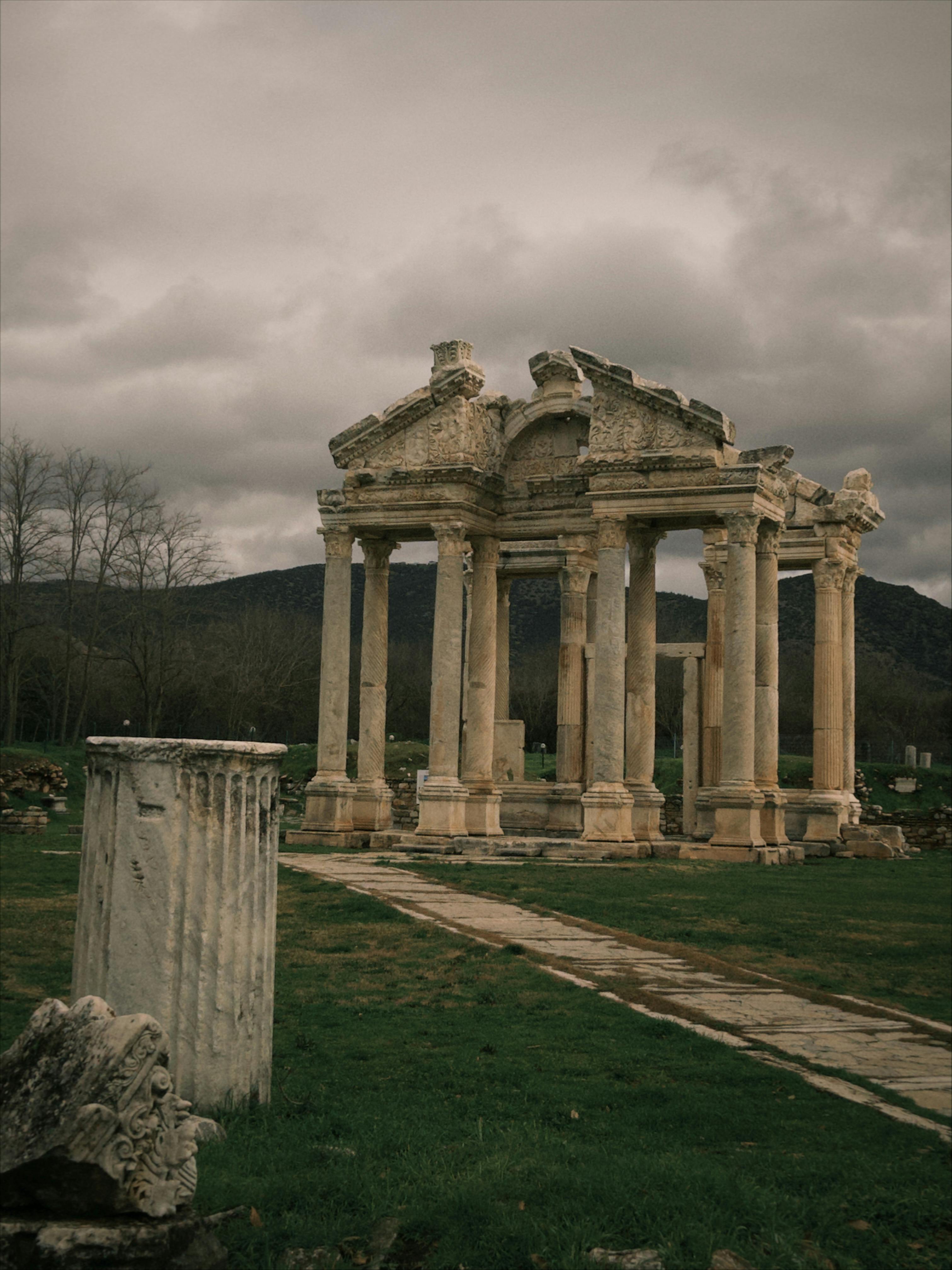 Explore the ancient ruins of Aphrodisias in Aydın, Türkiye, under dramatic skies.